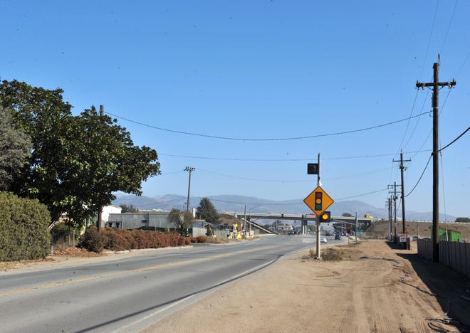 A traffic-light warning sign alerts drivers on Espinoza Road as they approach Christensen Road Nov. 1, 2019. The California Highway Patrol is investigating a hit-and-run crash that occurred west of the intersection at about 8:10 a.m. that morning