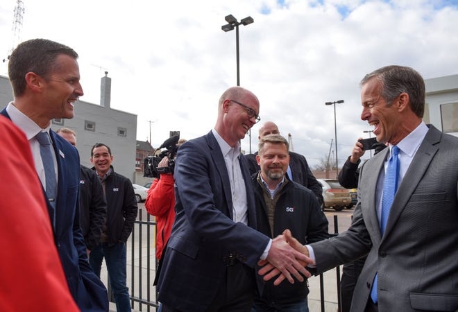 Senator John Thune and Verizon representative Craig Silliman shake hands in celebration of the 5G launch in Sioux Falls on Friday, November 1.