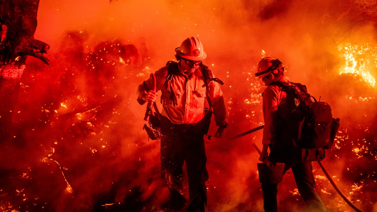 Firefighter Giannis Giagos battles the Maria Fire in Santa Paula, Calif., on Friday, Nov. 1, 2019. According to Ventura County Fire Department, the blaze has scorched more than 8,000 acres and destroyed at least two structures. (AP Photo/Noah Berger) ORG XMIT: CANB102