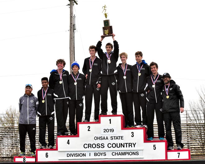 The St. Xavier Bombers hoist the Division1 team 1st place trophy at the 2019 OHSAA State Cross Country Champiionships, November 2, 2019.