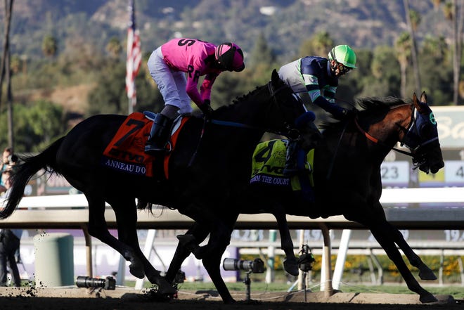 Storm the Court, right, with Flavien Prat, edges out Anneau D'or in the Breeders' Cup Juvenile horse race at Santa Anita, Friday, Nov. 1, 2019, in Arcadia, Calif. (AP Photo/Gregory Bull)