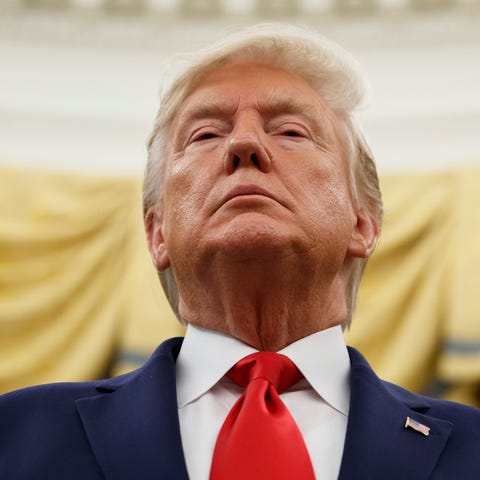 President Donald Trump stands during a Presidentia