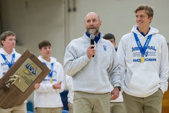 Memorial soccer head Coach Bill Vieth, center, introduces co-captain Sam Hodge, right, during the school assembly to celebrate the team's 2A state championship win at Robert M. Kent Athletic Center in Evansville, Monday morning, Nov. 4, 2019.
