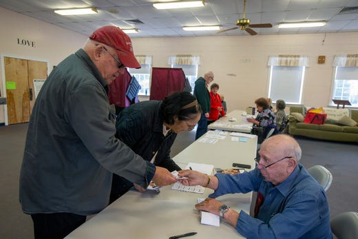 Jim and Dee Grossi of Toms River sign in with Victor Goldfarb of Manchester, a poll worker, before casting their vote on Election Day at the First United Methodist Church in Toms River, NJ Tuesday, November 5, 2019. 