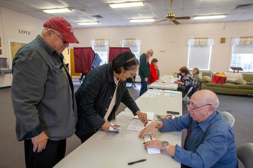 Jim and Dee Grossi of Toms River sign in with Victor Goldfarb of Manchester, a poll worker, before casting their vote on Election Day at the First United Methodist Church in Toms River, NJ Tuesday, November 5, 2019. 