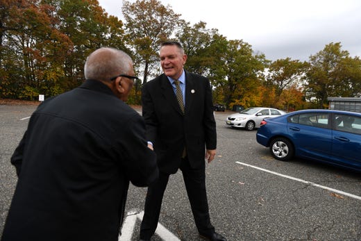 Sheriff Richard Berdnik shakes hands with a voter in the parking lot of School # 14 in Clifton before voting on Tuesday, November 5, 2019.