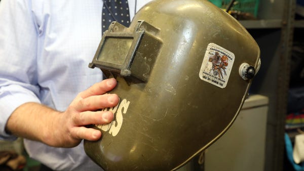 A welder's helmet waits to be returned to its owne