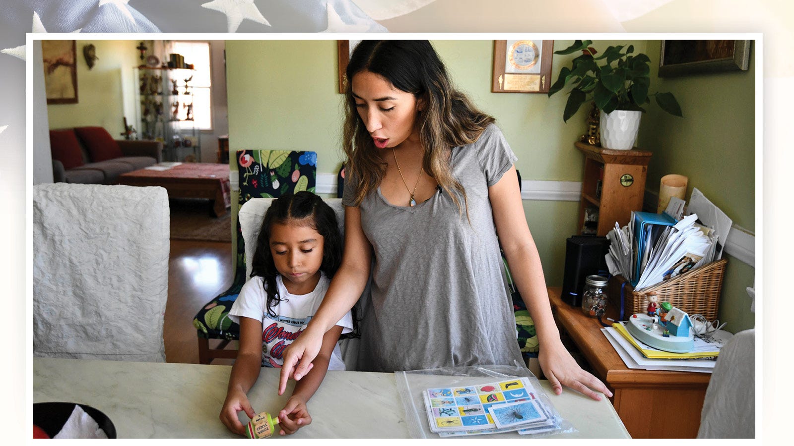 Linda Ortiz and her daughter, Sophie, prepare to play Lotería, a popular Spanish game. Sophie is part of a bilingual education class at UCLA Lab School, where she is learning 90% Spanish and 10% English.