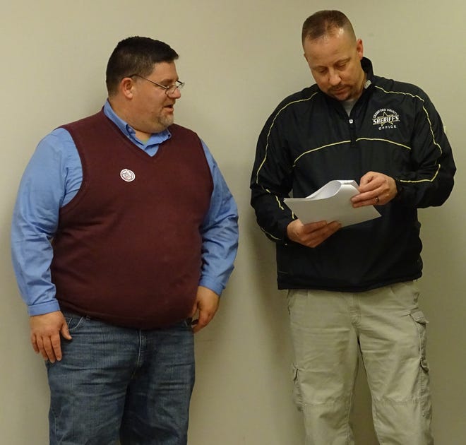 Crawford County Sheriff Scott Kent, right, reviews election results with county prosecutor Matt Crall at the Crawford County Board of Elections on Tuesday.