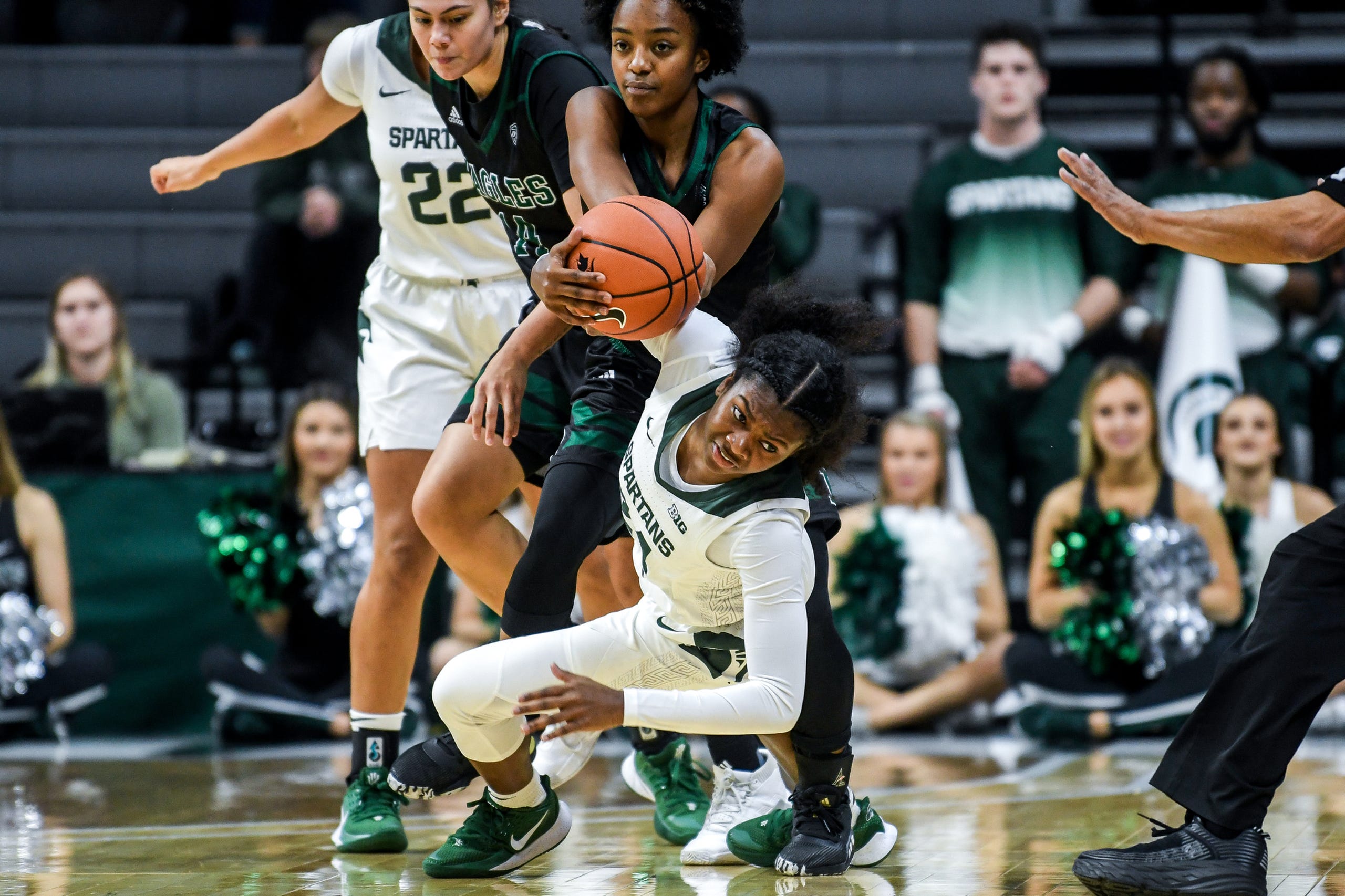 Michigan State's Nia Clouden, center, battles Eastern Michigan's Juanita Agosto, and JaBria Knight, left, for possession during the first quarter on Tuesday, Nov. 5, 2019, at the Breslin Center in East Lansing.