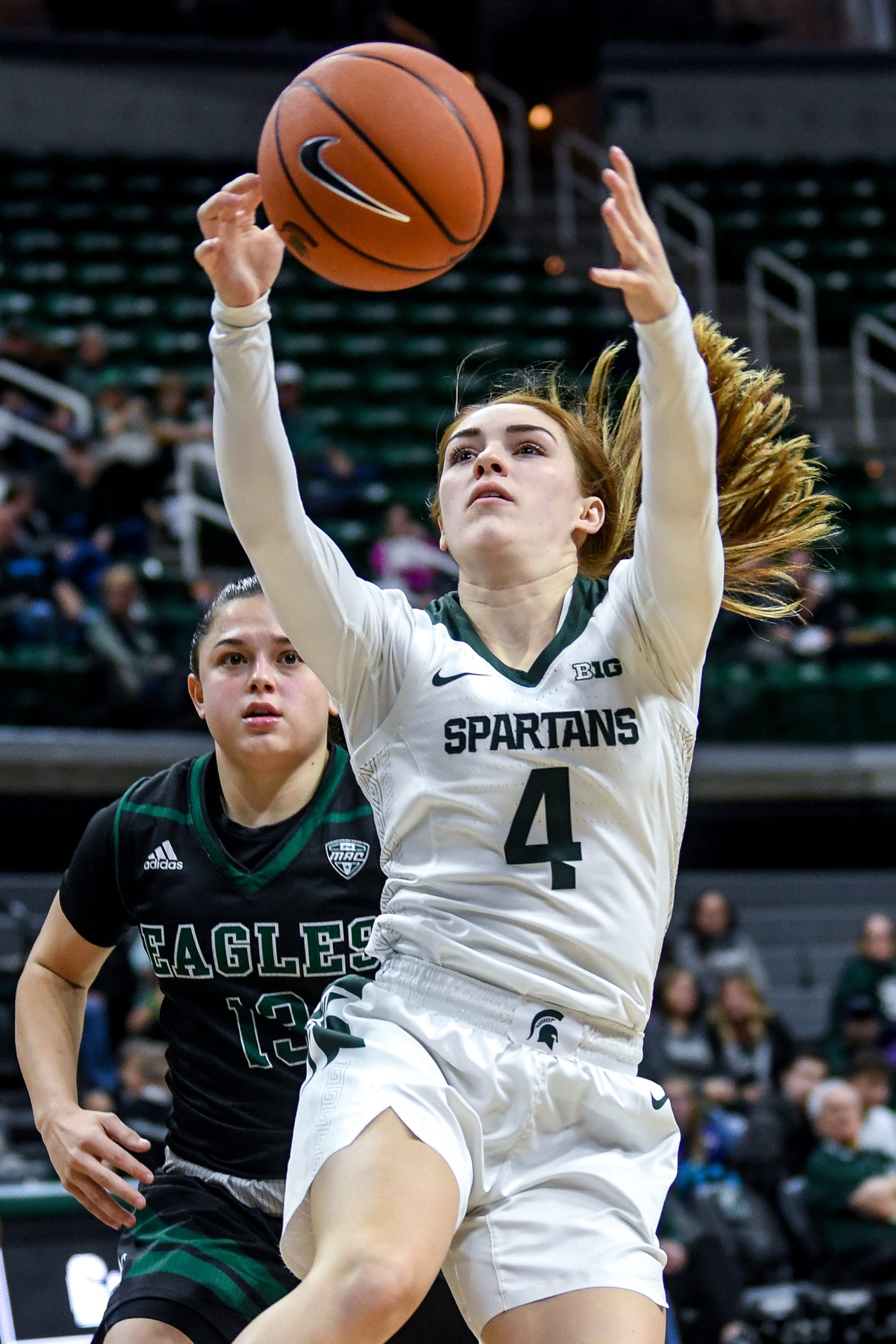 Michigan State's Taryn McCutcheon grabs a rebound as Eastern Michigan's Jenna Annecchiarico looks on during the fourth quarter on Tuesday, Nov. 5, 2019, at the Breslin Center in East Lansing.