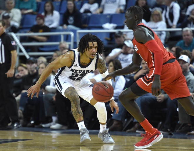 Nevada's Jazz Johnson defends against Utah during the Wolf Pack's season-opener on Tuesday.