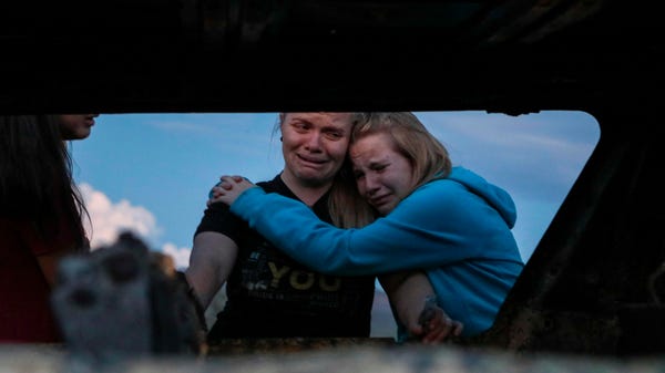 Members of the Lebaron family mourn while they wat