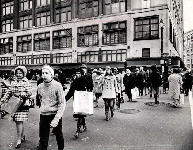 Shoppers cross Woodward under the watchful eye of traffic police who sound directions from their Hudson's lookout in 1970.
