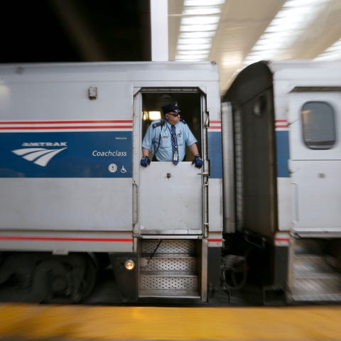 A conductor watches as the Amtrak Hiawatha line le