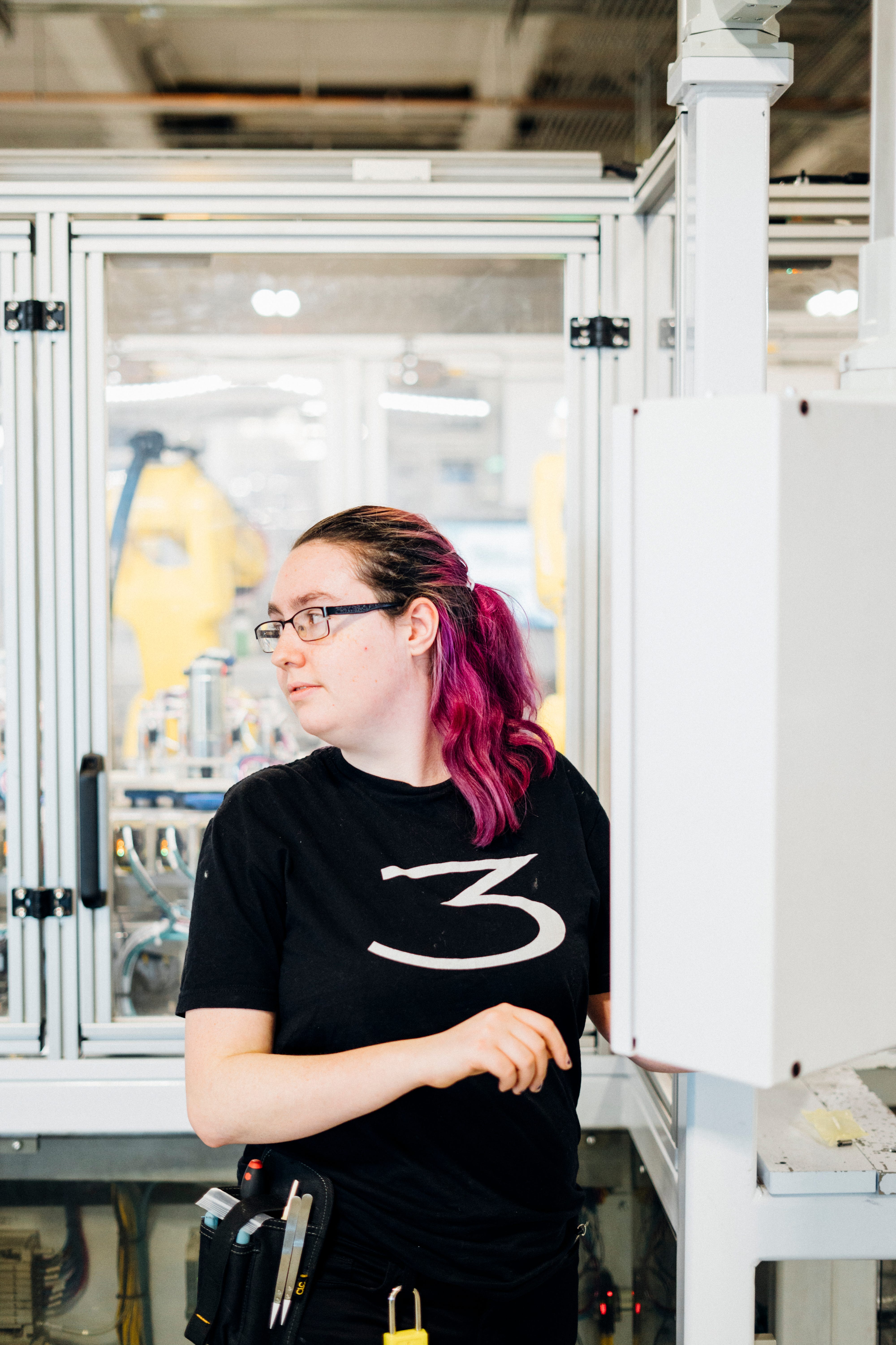 Isabelle West was hired at Tesla thanks to a program at her high school but struggled to find housing in the area. Here she stands at her work station inside the Tesla Gigafactory.