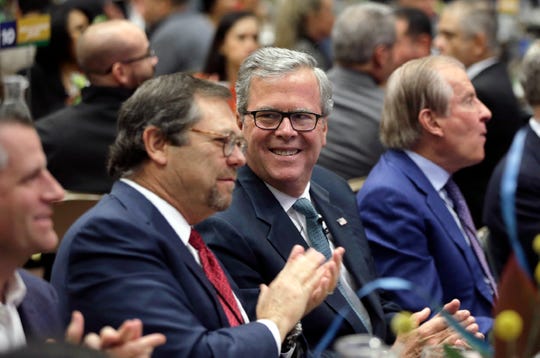 Jeb Bush talks with El Paso businessman Paul Foster before speaking at the U.S.-Mexico Border Summit Thursday.