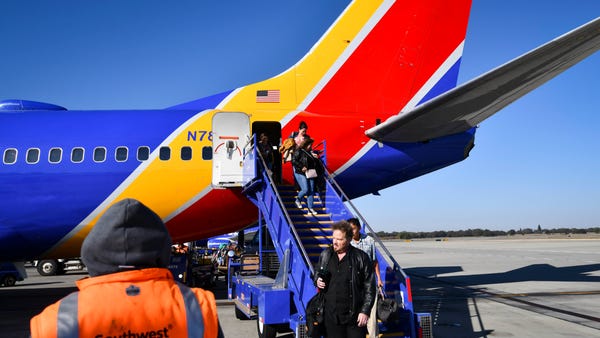 Travelers exit a Southwest Airlines flight from th