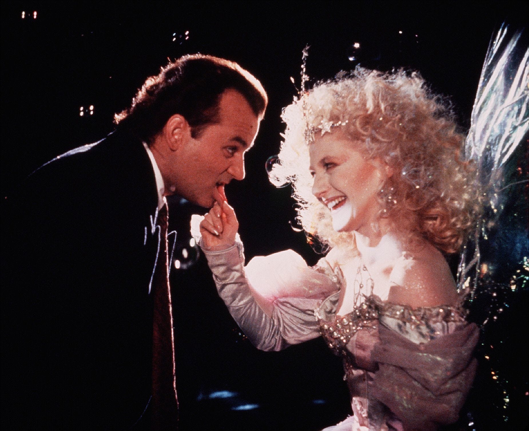 Humbug-y TV executive Frank Cross (Bill Murray) encounters a playfully vicious Ghost of Christmas Past (Carol Kane) in "Scrooged."