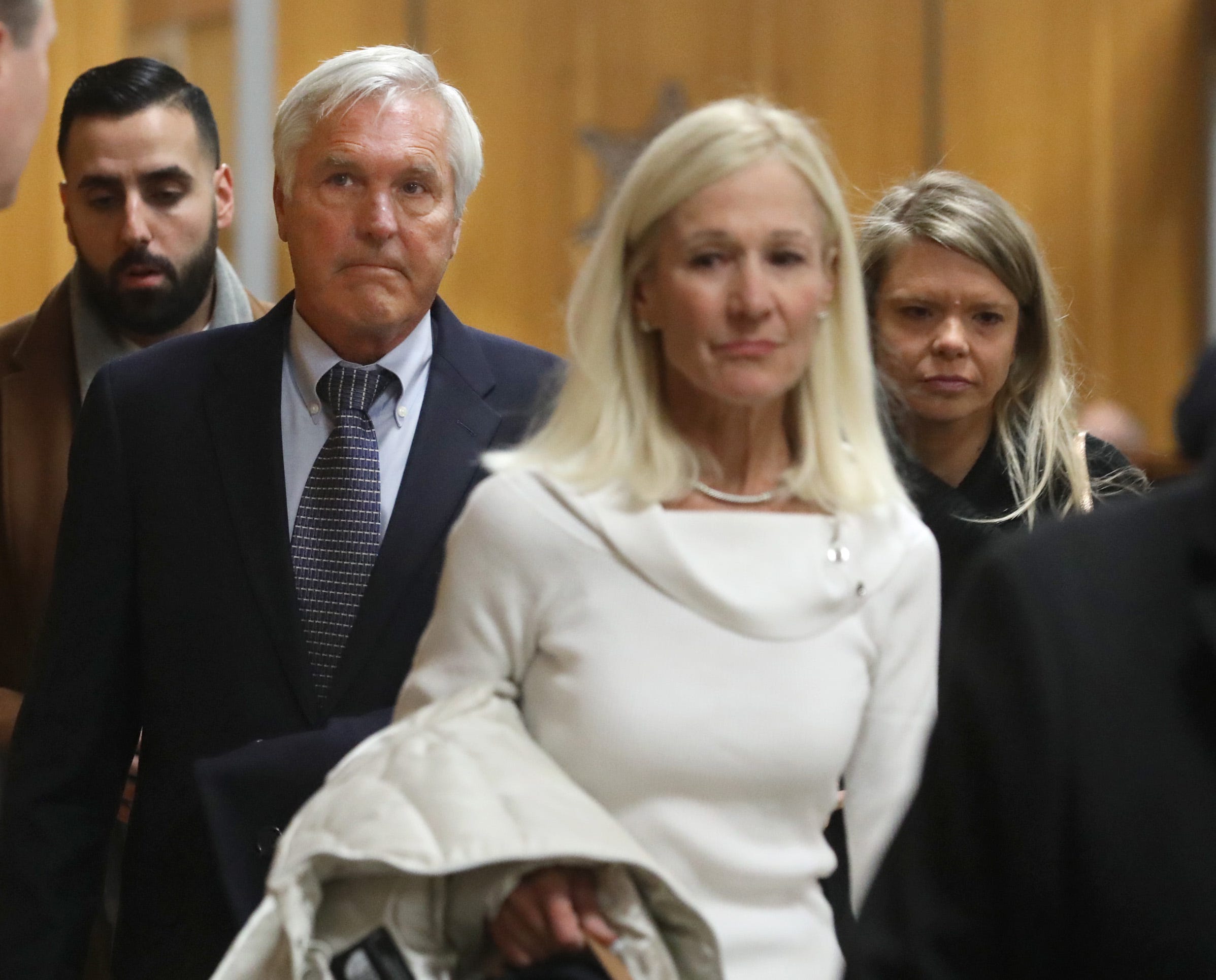 James Krauseneck, second from left, walks into court, with daughter Sara, right, and wife Sharon, to face charges in the 1982 murder of his then-wife Cathleen, Friday, Nov. 8, 2019 at the Hall of Justice in Rochester. 