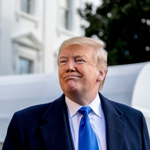 President Donald Trump smiles while speaking to re
