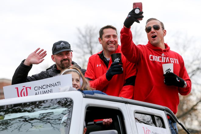 Grand Marshall Kevin Youkilis, far left, waves during the University of Cincinnati Homecoming Parade, Saturday, Nov. 9, 2019, along Calhoun Street and Clifton Avenue in Clifton Heights. The University of Cincinnati is celebrating its bicentennial, founded in 1819. 