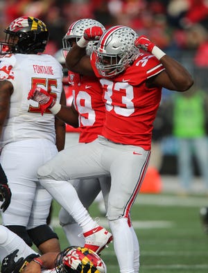Ohio State freshman end Zach Harrison flexes (which drew a personal foul flag) after recording one of the Buckeyes' seven sacks in the 73-14 rout of Maryland