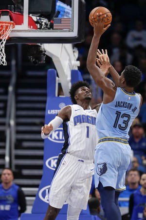 The Memphis Grizzlies' Jaren Jackson Jr. (13) shoots over the Orlando Magic's Jonathan Isaac (1) during the first half on Friday in Orlando.