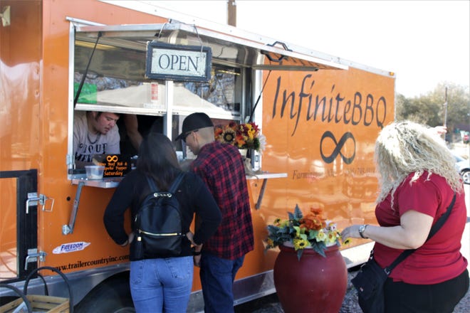 Customers line up at InfiniteBBQ food truck on Saturday Nov. 9, 2019, in Farmington.