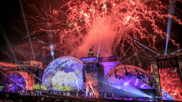 Fireworks erupt over the Brandenburg Gate during c