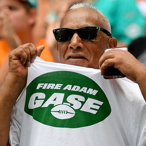 A Jets fan wears a "Fire Adam Gase" t-shirt during