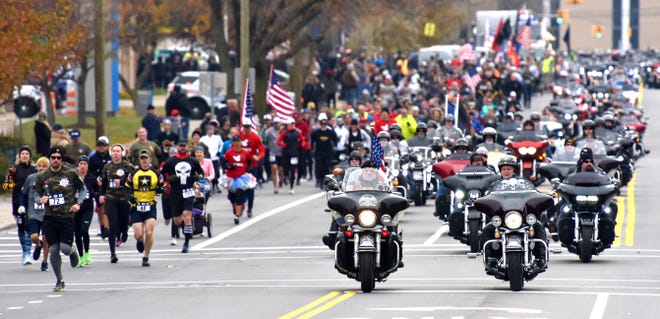 Motorcyclists escort runners and walkers of the 4 Star 4 Mile Race along Trumbull Avenue in Corktown on Sunday, November 10, 2019.