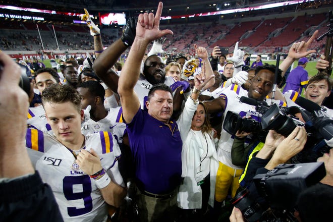 LSU head coach Ed Orgeron celebrates with his players after defeating Alabama 46-41 in an NCAA college football game, Saturday, Nov. 9, 2019, in Tuscaloosa , Ala. (AP Photo/John Bazemore)