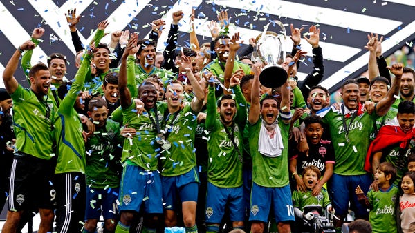 The Seattle Sounders celebrate with the MLS Cup.