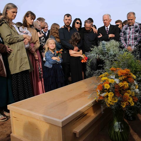 Family and friends attend the burial service of Ch