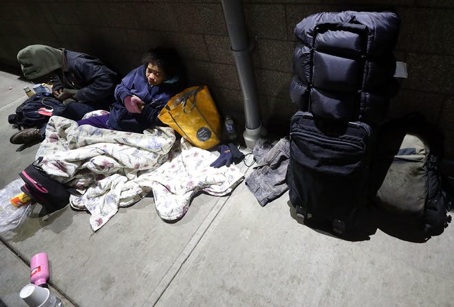 David Lund, left, and Katrina Sprague prepare to spend the night outside of the Salvation Army building on Thursday.