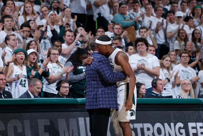 Michigan State's Cassius Winston and coach Tom Izzo embrace as Winston leaves the the team's NCAA college basketball game against Binghamton, Sunday, Nov. 10, 2019, in East Lansing, Mich. Michigan State won 100-47. (AP Photo/Al Goldis)