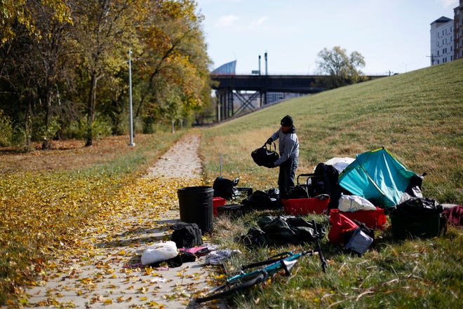 Aaron Hoskins, 25, packs up his camp and his belongings  near the banks of the Ohio River in Covington, Ky., on Friday, Nov. 8, 2019. Hoskins had been sleeping near the river's edge but was packing his camp and preparing to migrate toward Florence. 