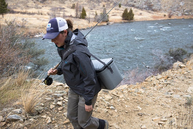 An angler hikes along the Madison River in Bear Trap Canyon in this 2015 file photo.