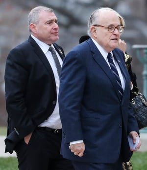 Photo shows the lawyer for US President Donald Trump, Rudy Giuliani, right, and a businessman who served as Giuliani's associate in Ukraine, Lev Parnas, left, as they arrived for the funeral of late US President George H.W. Bush at the National Cathedral in Washington, DC on December 5, 2018. (Photo by Alex Edelman / AFPX via Getty Images)