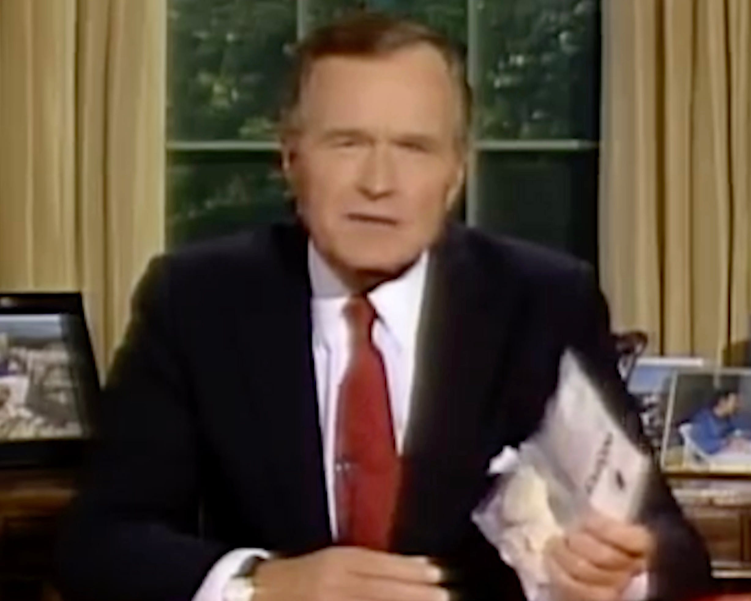 President George H. W. Bush during a 1989 televised address holds up a bag of crack cocaine purchased from a dealer outside the White House.