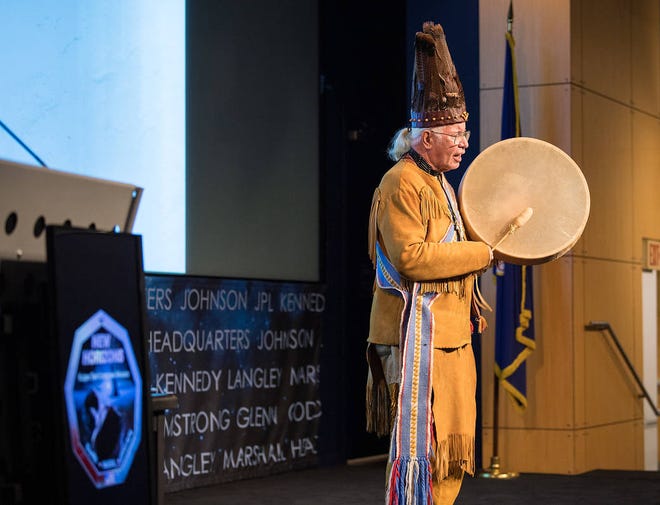 Reverend Nick Miles, Tecumseh Red Cloud, Pamunkey Tribe, performs a traditional Algonquian chant of “Thank you, O Great Spirit,” at a naming ceremony for 2014 MU69, a celestial body discovered by the New Horizons mission and Hubble Space Telescope, formerly nicknamed “Ultima Thule”, Tuesday, Nov. 12, 2019, at NASA Headquarters in Washington. The new name, “Arrokoth,” means “sky” and is from the Algonquian Languages, spoken by the Powhatan tribes of the region of Maryland it was discovered in. Tribal elders from those tribes approved of the name and participated in the ceremony. Photo Credit: (NASA/Aubrey Gemignani)