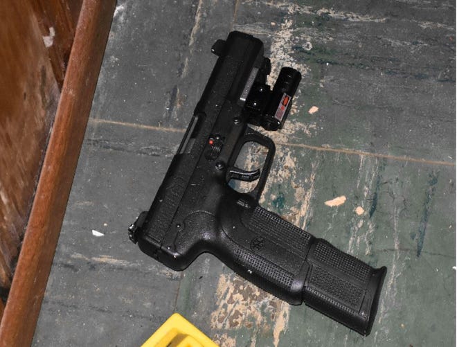 One of two loaded FN Five-Seven 5.7 mm pistols pistols with extended 30 round magazines were located in the basement.