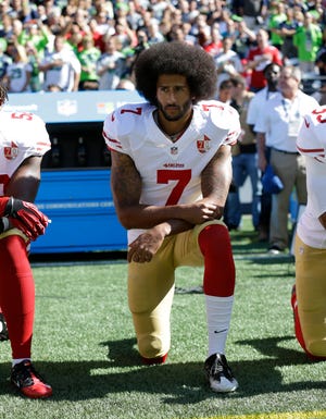In this Sept. 25, 2016, file photo, San Francisco 49ers' Colin Kaepernick kneels during the national anthem before an NFL football game against the Seattle Seahawks, in Seattle.