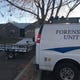 A Larimer County Sheriff's Office van sits outside the Loveland home where police were investigating a possible homicide and fired shots at a female suspect, who died.