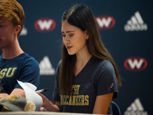 West High School’s Hannah Burkhart signs with ETSU for XC and Track during an athletic signing day ceremony in West’s auditorium Wednesday, Nov. 13, 2019.