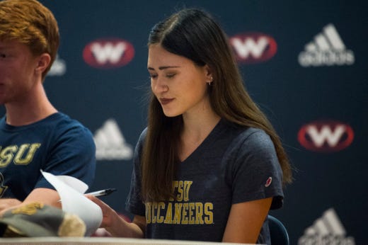 West High School’s Hannah Burkhart signs with ETSU for XC and Track during an athletic signing day ceremony in West’s auditorium Wednesday, Nov. 13, 2019.