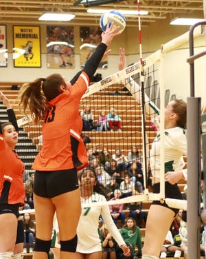 Ceila Cullen of Brighton goes up for the block in Brighton's 3-0 loss to Novi in a regional semifinal volleyball match on Tuesday, Nov. 12, 2019.