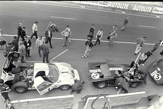The winning #2 Ford GT40, right, and second-place #1 car, left, in the Le Mans pits prior to the 1966 race.