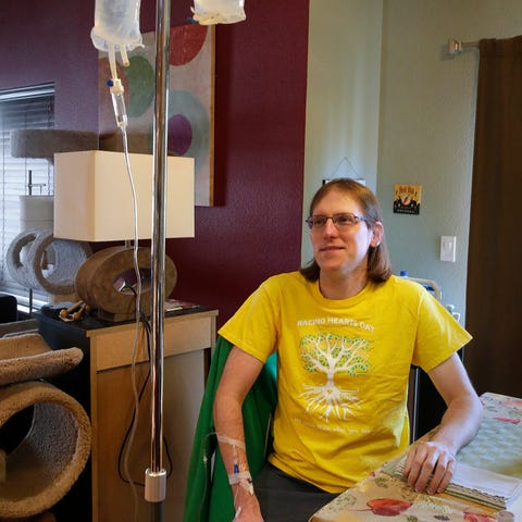 Corey Sukalich gets an IV infusion at his home. Su